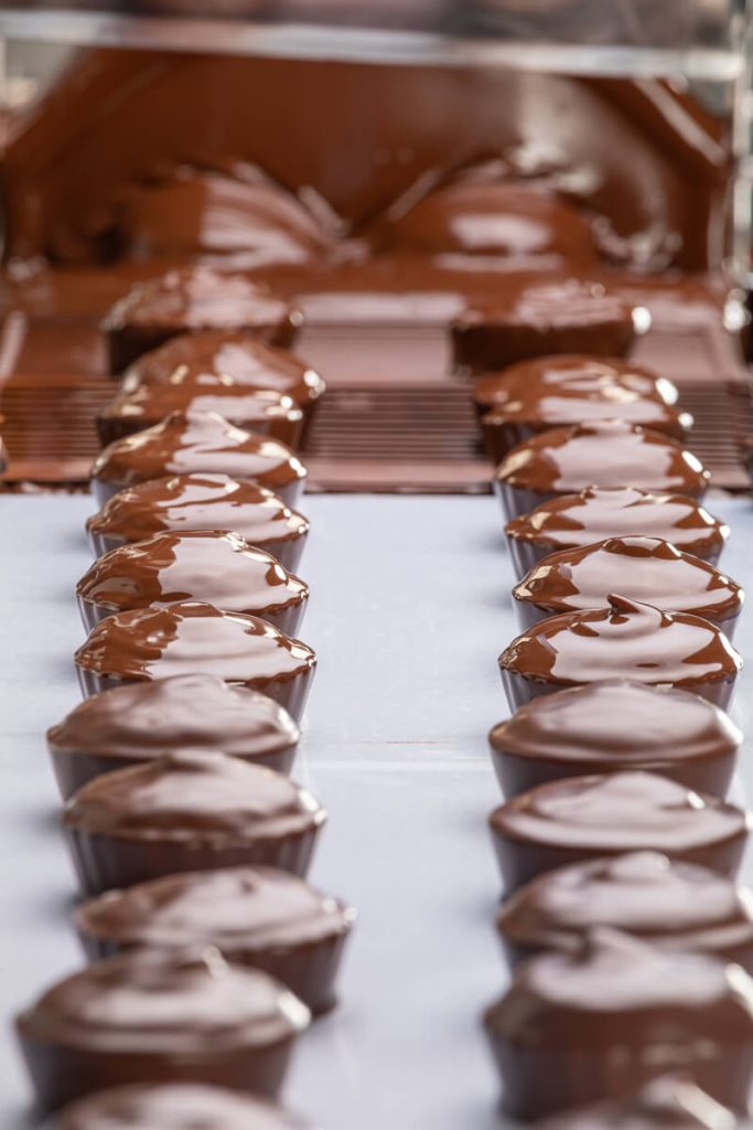 Chocolate enrobing line coating pralines